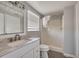 This bathroom features a white vanity with a marble countertop and a shower with white tile surround at 508 2Nd St, Indian Rocks Beach, FL 33785