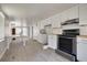 This kitchen features white cabinets and stainless steel appliances that offer a view to a separate living space at 508 2Nd St, Indian Rocks Beach, FL 33785