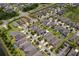 An aerial view of a neighborhood with well-manicured lawns and a pond at 5239 Fallen Leaf Dr, Riverview, FL 33578