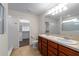 En-suite bathroom featuring double sinks, walk-in closet, and tile flooring at 5239 Fallen Leaf Dr, Riverview, FL 33578