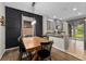 Open dining area featuring a stylish black accent wall and a view of the backyard at 5239 Fallen Leaf Dr, Riverview, FL 33578
