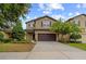 Charming two-story home with an attached two-car garage and a well-manicured lawn at 5239 Fallen Leaf Dr, Riverview, FL 33578