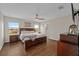 Spacious main bedroom with wood floors, a ceiling fan, and ample natural light at 5239 Fallen Leaf Dr, Riverview, FL 33578
