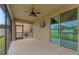 Relaxing screened patio with a ceiling fan, sliding glass doors to the yard, and an outside view at 5239 Fallen Leaf Dr, Riverview, FL 33578