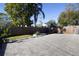 Large backyard with a paved patio area, wood fence, and green landscaping at 5528 40Th N St, St Petersburg, FL 33714