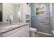 Updated bathroom with granite countertop vanity, modern fixtures, and a tiled glass-enclosed shower for a luxurious feel at 5528 40Th N St, St Petersburg, FL 33714