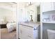 Elegant bathroom featuring a granite countertop vanity and neutral decor adjacent to a bedroom at 5528 40Th N St, St Petersburg, FL 33714