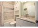 Updated bathroom with a tiled shower, granite countertop, and white vanity at 5528 40Th N St, St Petersburg, FL 33714