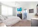Cozy bedroom with neutral tones, comfortable carpet, decorative accents, and natural light creates a relaxing atmosphere at 5528 40Th N St, St Petersburg, FL 33714