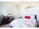 Cozy bedroom with a comfortable bed, a desk area, and soft natural light at 5528 40Th N St, St Petersburg, FL 33714