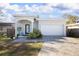Charming single-story home featuring a well-manicured lawn and a two-car garage with a brick-paved driveway at 5528 40Th N St, St Petersburg, FL 33714
