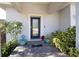 Inviting front porch with decorative plants, an ADT security sign, and a stylish glass-paneled front door at 5528 40Th N St, St Petersburg, FL 33714