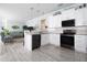 Modern kitchen featuring white cabinetry, stainless steel appliances, and an open layout perfect for entertaining at 5528 40Th N St, St Petersburg, FL 33714