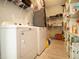 Functional laundry area with appliances, storage shelves, and ample space for household tasks at 5528 40Th N St, St Petersburg, FL 33714
