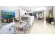 Spacious living room featuring hardwood floors, modern furniture, and an open layout, perfect for entertaining and relaxation at 5528 40Th N St, St Petersburg, FL 33714