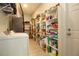 Well-organized pantry with ample shelving for storage, plus a washer and dryer at 5528 40Th N St, St Petersburg, FL 33714