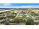 Expansive aerial view showcasing a residential community with lush landscaping and tranquil lake, offering a serene setting at 5580 S Salford Blvd, North Port, FL 34287
