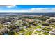 Expansive aerial view of a residential neighborhood with tree-lined streets under a partly cloudy sky at 5580 S Salford Blvd, North Port, FL 34287