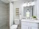 Bright bathroom featuring a shower, updated vanity, decorative mirror and stylish wall art at 5580 S Salford Blvd, North Port, FL 34287
