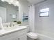 Bathroom featuring a bathtub with shower, bright natural light and decorative mirror at 5580 S Salford Blvd, North Port, FL 34287