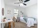 Cozy bedroom features a ceiling fan, window view, and comfortable decor at 5580 S Salford Blvd, North Port, FL 34287