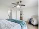 Cozy bedroom features soft carpet, a ceiling fan, and access to a private bathroom, offering comfort and convenience at 5580 S Salford Blvd, North Port, FL 34287
