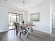 Chic dining room with modern table set and sliding glass doors to backyard at 5580 S Salford Blvd, North Port, FL 34287