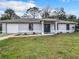 Charming single-story home with a well-maintained lawn, featuring a two-car garage and neutral-toned facade at 5580 S Salford Blvd, North Port, FL 34287