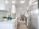 Bright, modern kitchen with stainless steel appliances and quartz countertops, dining area in background at 5580 S Salford Blvd, North Port, FL 34287