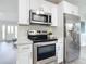 Well-equipped kitchen features stainless steel appliances and ample counter space at 5580 S Salford Blvd, North Port, FL 34287