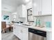 Modern kitchen with white cabinets, stainless steel appliances, and a view to the dining area at 5580 S Salford Blvd, North Port, FL 34287