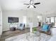 Bright living room features modern decor, hardwood floors, and a ceiling fan at 5580 S Salford Blvd, North Port, FL 34287