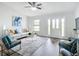 Inviting living room with vaulted ceilings, modern furnishings, and a view of the home's entry at 5580 S Salford Blvd, North Port, FL 34287