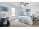 Serene main bedroom features a queen bed, ceiling fan and natural light at 5580 S Salford Blvd, North Port, FL 34287