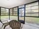 Enclosed patio with comfortable seating, ideal for enjoying the serene backyard view at 5580 S Salford Blvd, North Port, FL 34287