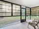 Inviting screened porch with seating and a view of the lush backyard at 5580 S Salford Blvd, North Port, FL 34287