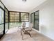 Relaxing screened porch with chairs and view of the yard at 5580 S Salford Blvd, North Port, FL 34287