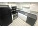 Efficient kitchen with stainless steel appliances, white cabinetry, and a dark countertop at 6342 Newtown Cir # A4, Tampa, FL 33615