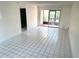 Bright living room featuring tile floors, neutral walls, and sliding glass doors to a screened lanai at 6342 Newtown Cir # A4, Tampa, FL 33615