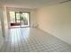 Bright living room with tile floors, neutral walls, and sliding glass doors leading to a screened lanai at 6342 Newtown Cir # A4, Tampa, FL 33615