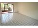 Bright living room featuring tile floors, neutral walls, and sliding glass doors to a screened lanai at 6342 Newtown Cir # A4, Tampa, FL 33615