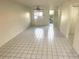Spacious living room features tile floors and neutral walls, with natural light streaming through the windows at 6342 Newtown Cir # A4, Tampa, FL 33615