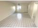 Open living room features tile floors and neutral walls, with a window and entry door at 6342 Newtown Cir # A4, Tampa, FL 33615