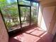 Relaxing screened-in porch with lush greenery and exterior access at 6342 Newtown Cir # A4, Tampa, FL 33615