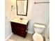 Bathroom featuring a dark wooden vanity with sink, mirror, and a toilet at 6344 Newtown Cir # B2, Tampa, FL 33615