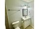 Bathroom featuring a bright white vanity with sink, mirror, toilet and brushed nickel accents at 6344 Newtown Cir # B2, Tampa, FL 33615