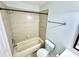 Bathroom with neutral tile, shower, vanity, toilet, and brushed nickel fixtures at 6344 Newtown Cir # B2, Tampa, FL 33615