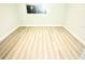 A spacious bedroom boasts light, wood-look flooring and fresh, neutral paint throughout at 6344 Newtown Cir # B2, Tampa, FL 33615