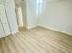 A spacious bedroom boasts light, wood-look flooring and fresh, neutral paint throughout at 6344 Newtown Cir # B2, Tampa, FL 33615