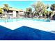 Relaxing community pool with seating, landscaping, and nearby buildings at 6344 Newtown Cir # B2, Tampa, FL 33615